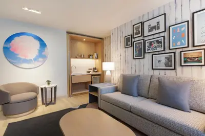 a living room with a couch and a desk at The Viv Hotel, Anaheim, a Tribute Portfolio Hotel in Anaheim