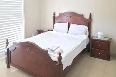 a bedroom with a large wooden bed with white sheets and pillows at Los Angeles Retreat Close to Hotspots in Los Angeles