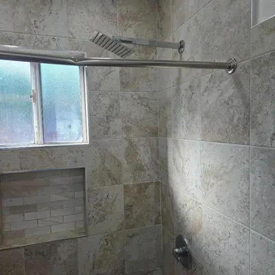 a bathroom with a shower with a stone wall at Los Angeles Retreat Close to Hotspots in Los Angeles