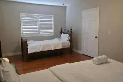 a bedroom with two beds and a window with blinds at Los Angeles Retreat Close to Hotspots in Los Angeles