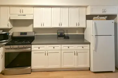 a kitchen with white cabinets and a white refrigerator at Los Angeles Retreat Close to Hotspots in Los Angeles