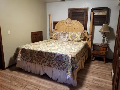 a bedroom with a bed with a quilt on it at Grey Squirrel Resort in Big Bear Lake