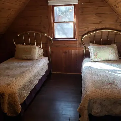 two beds in a room with a window at Grey Squirrel Resort in Big Bear Lake