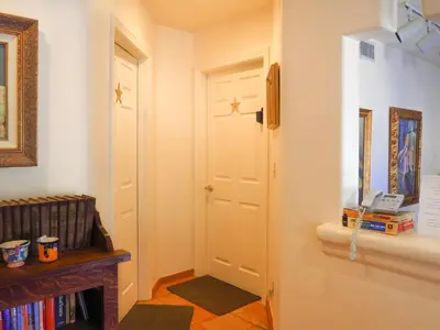 a hallway with a white door and a book shelf at Topanga Canyon Inn Bed and Breakfast in Topanga