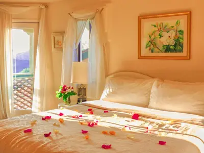 a bedroom with a bed with roses on it at Topanga Canyon Inn Bed and Breakfast in Topanga
