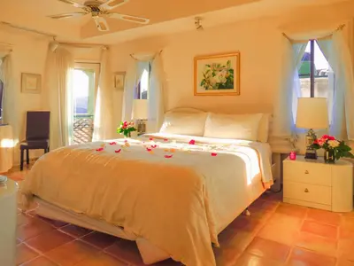 a bedroom with a bed with roses on it at Topanga Canyon Inn Bed and Breakfast in Topanga