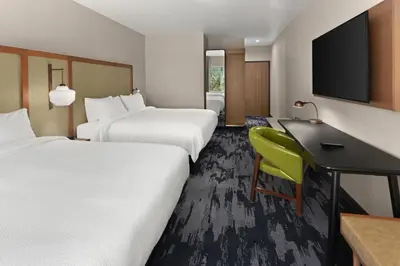 a hotel room with two beds and a desk at Fairfield by Marriott Inn & Suites Anaheim Los Alamitos in Los Alamitos