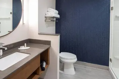 a bathroom with a toilet and a sink at Fairfield by Marriott Inn & Suites Anaheim Los Alamitos in Los Alamitos