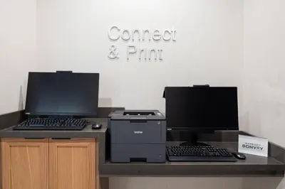a desk with two computer monitors and a printer at Fairfield by Marriott Inn & Suites Anaheim Los Alamitos in Los Alamitos