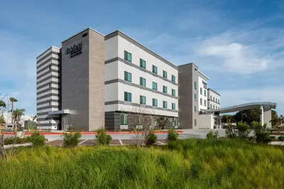 a large white building with at Fairfield by Marriott Inn & Suites Anaheim Los Alamitos in Los Alamitos