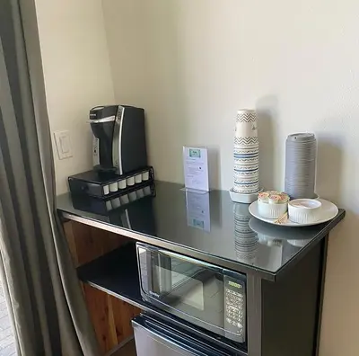 a counter with a coffee maker and a microwave at Hollywood’s Suite in Los Angeles