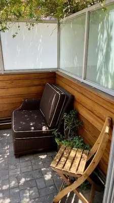a chair and a couch sitting on a porch at Hollywood’s Suite in Los Angeles