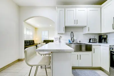 a kitchen with white cabinets and a white counter top at Stylish Modern Home, AC, Parking & Near FWYs in Santa Ana