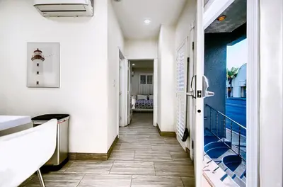 a hallway with a door leading to a room with a lighthouse at Stylish Modern Home, AC, Parking & Near FWYs in Santa Ana
