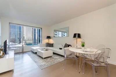 a living room with a couch and a table at Cityscape Luxury High-Rise 1-Bedroom in Los Angeles