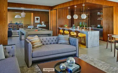 a living room with a couch and a pool table at Cityscape Luxury High-Rise 1-Bedroom in Los Angeles