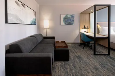 a living room with a couch and a bed at SpringHill Suites by Marriott Valencia in Valencia