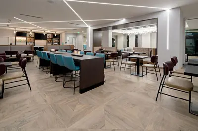 a restaurant with tables and chairs in a room at SpringHill Suites by Marriott Valencia in Valencia