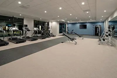a gym with treadmills and ellipticals in a building at SpringHill Suites by Marriott Valencia in Valencia