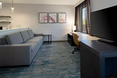 a living room with a couch and a flat screen tv at Residence Inn by Marriott Valencia in Valencia