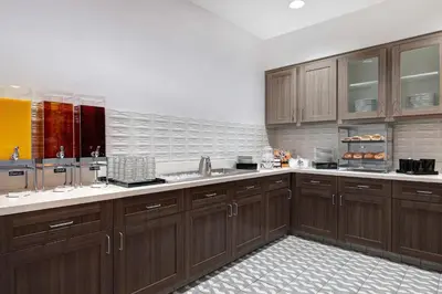 a large kitchen with wooden cabinets and a sink at Homewood Suites By Hilton Santa Clarita/Valencia, Ca in Santa Clarita