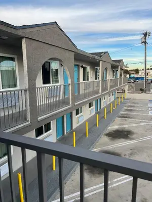 a row of apartment buildings with yellow poles at Arlo Motel near LAX, SoFi Stadium in Inglewood