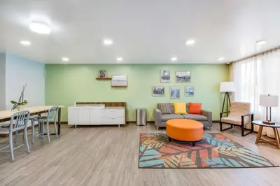 a waiting room with a couch and a table at WoodSpring Suites Bakersfield Airport in Bakersfield