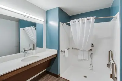 a bathroom with a sink and a mirror at WoodSpring Suites Bakersfield Airport in Bakersfield