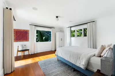 a white bedroom with a bed and two windows at 50 PCT OFF! Malibu Ocean Escape, Pool, Walk to Beach in Malibu
