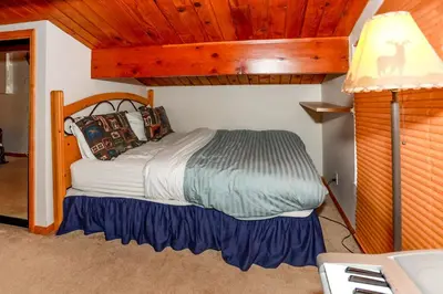 a bedroom with a bed in a room at Mountain Adventure - 1931 by Big Bear Vacations in Big Bear Lake