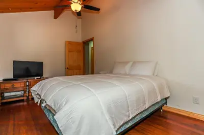a bedroom with a bed and a television on a table at Shasta Mountain Cabin - 1916 by Big Bear Vacations in Big Bear City