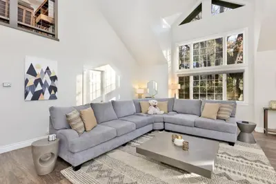 a living room with a couch and a table at Splash Mountain - 1904 by Big Bear Vacations in Big Bear Lake