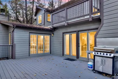 a house with a deck and a grill at Splash Mountain - 1904 by Big Bear Vacations in Big Bear Lake