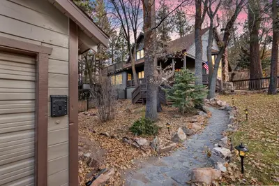 a house with a stone path next to a house at Splash Mountain - 1904 by Big Bear Vacations in Big Bear Lake