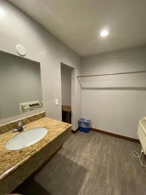 a bathroom with a sink and a mirror at Sandman Motel in Los Angeles