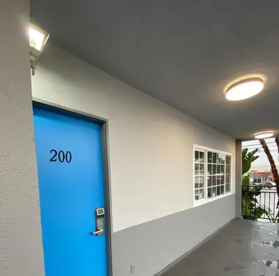 a blue door in a building with the number on it at Sandman Motel in Los Angeles
