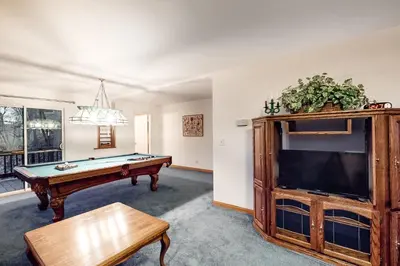 a living room with a pool table and a tv at The House Of Light and Sky in Lake Arrowhead