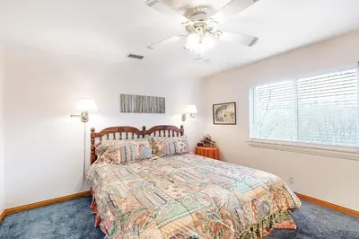 a bedroom with a bed and a ceiling fan at The House Of Light and Sky in Lake Arrowhead