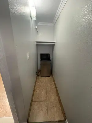 a small room with a hallway with a door and a wall at Seaway Motel in Los Angeles