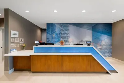 a lobby with a blue counter in a building at SpringHill Suites by Marriott Anaheim Placentia Fullerton in Placentia