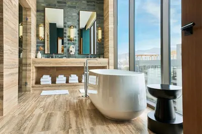 a bathroom with a tub and a large window at The Hollywood Grande, Autograph Collection in Los Angeles