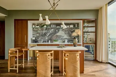 a kitchen with a table and some chairs at The Hollywood Grande, Autograph Collection in Los Angeles