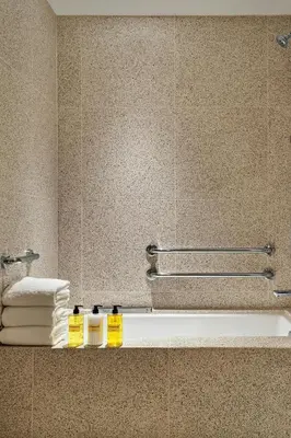 a bathroom with a sink and a mirror and towels at The Hollywood Grande, Autograph Collection in Los Angeles