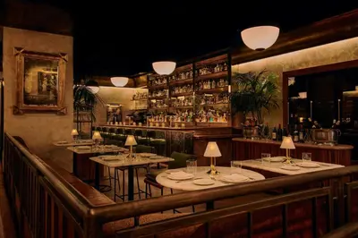 a restaurant with tables and chairs and a bar at The Hollywood Grande, Autograph Collection in Los Angeles