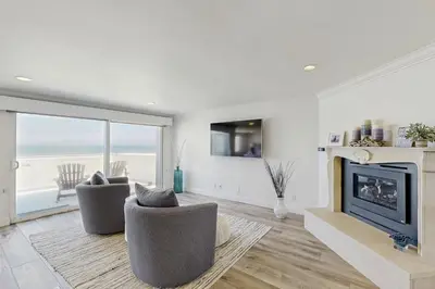 a living room with two chairs and a fireplace at Savor the View in Oxnard
