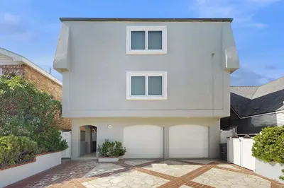 a white house with two garage doors at Savor the View in Oxnard