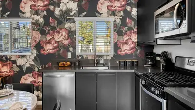 a kitchen with pink flowers on the wall at Art Deco by AvantStay in Los Angeles