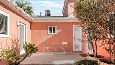 a patio with chairs and a table next to a building at Art Deco by AvantStay in Los Angeles