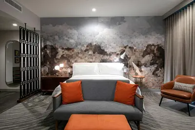 a bedroom with a bed and a couch and a chair at Le Meridien Pasadena Arcadia in Arcadia