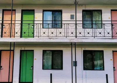 a building with colorful doors and a balcony at The Bell Vista in Burbank